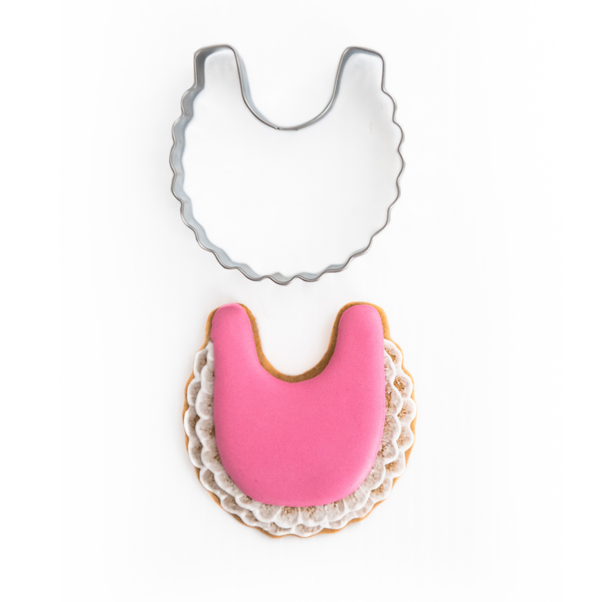 Baby Bib Cookie Cutter with Decorated Cookie with pink royal icing and white lace edging