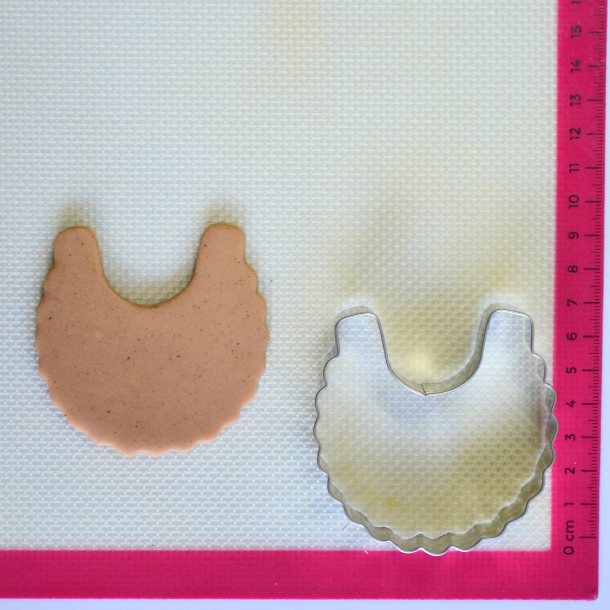 Baby bib with ruffled edges cookie cutter stainless steel 7cm with cookie dough cutout
