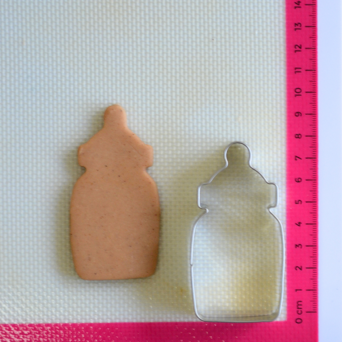 Baby bottle cookie cutter with cookie dough cutout