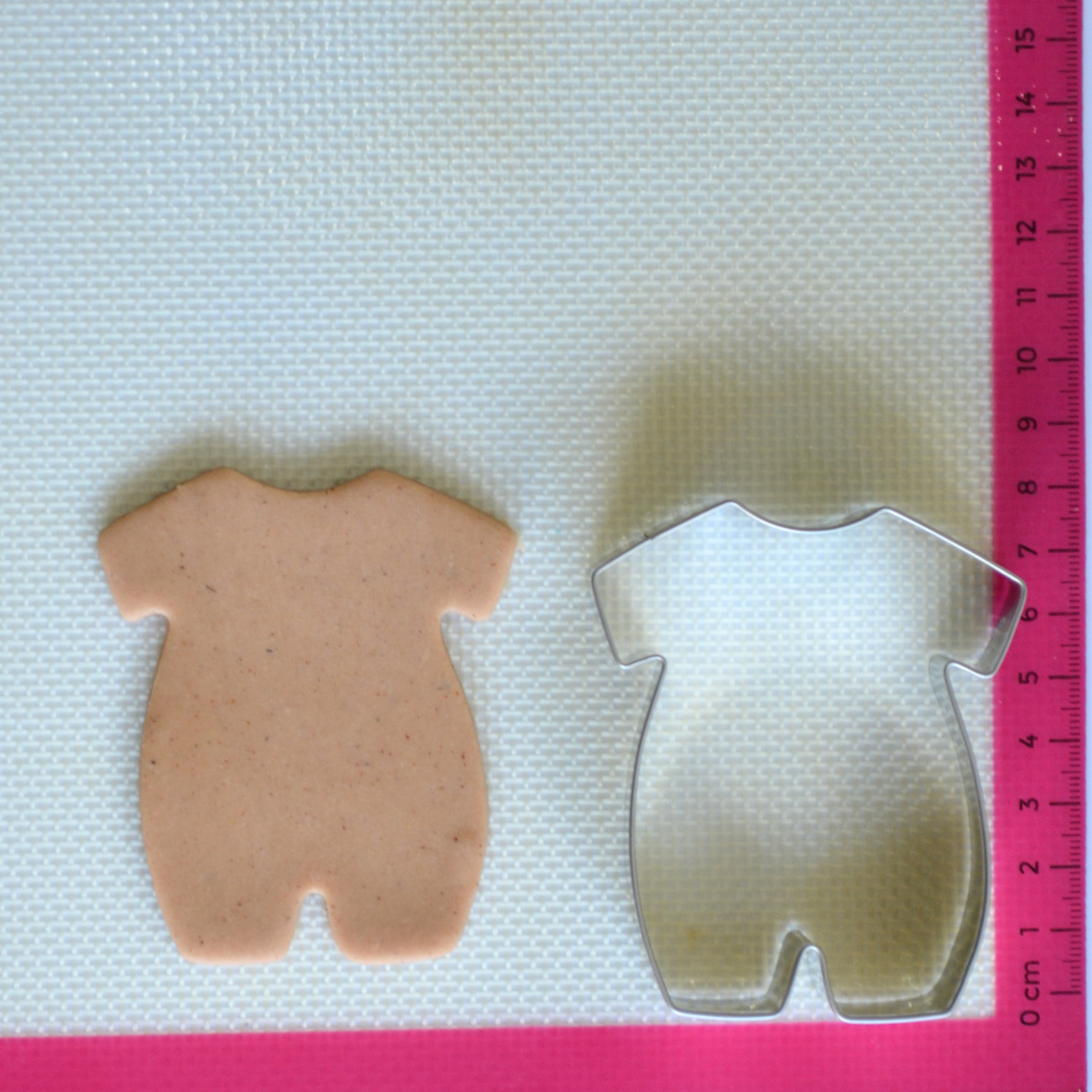 Stainless steel baby suit cookie cutter with cookie dough cutout