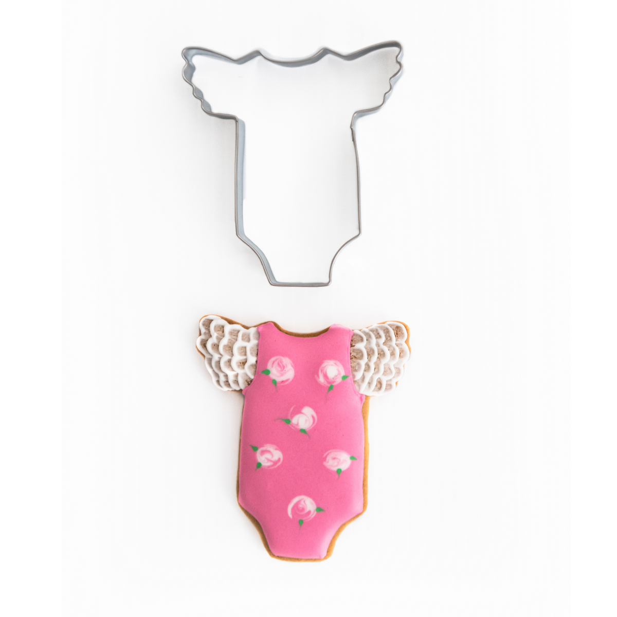 Cute baby girl suit cookie cutter with cookie decorated with pink royal icing and flowers with lace sleeves
