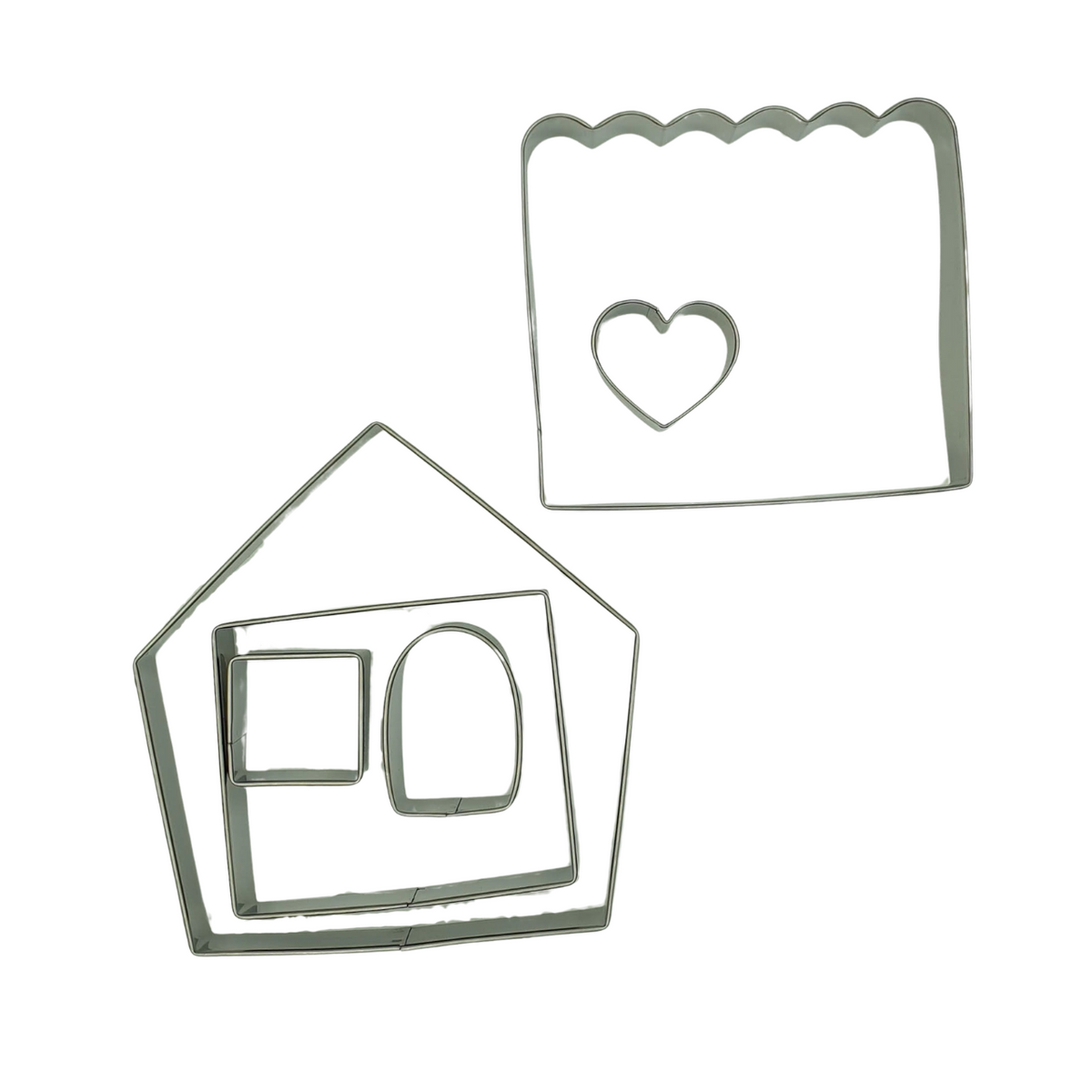 The 6 stainless steel cookie cutters included in our gingerbread house set including the front/back, side, roof, door, window and heart.