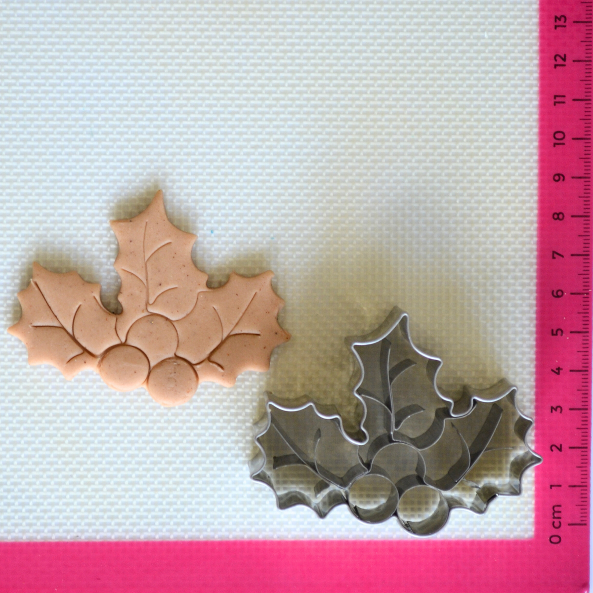 Holly cookie cutter with dough cutout showing internal details