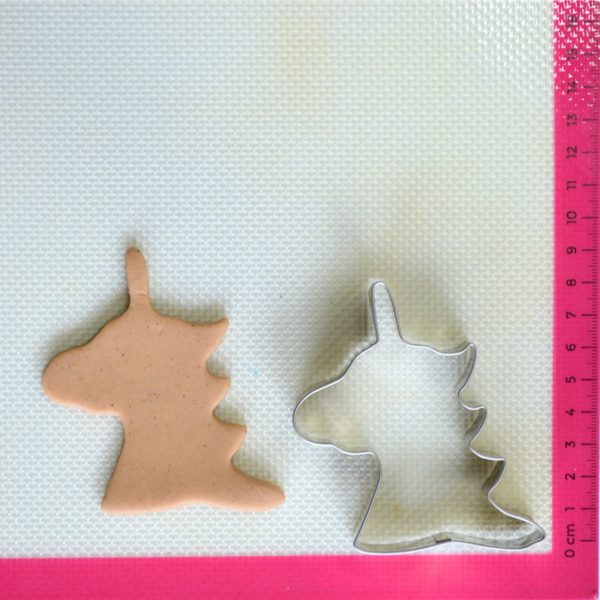 Unicorn cookie cutter made from stainless steel with cookie dough cutout